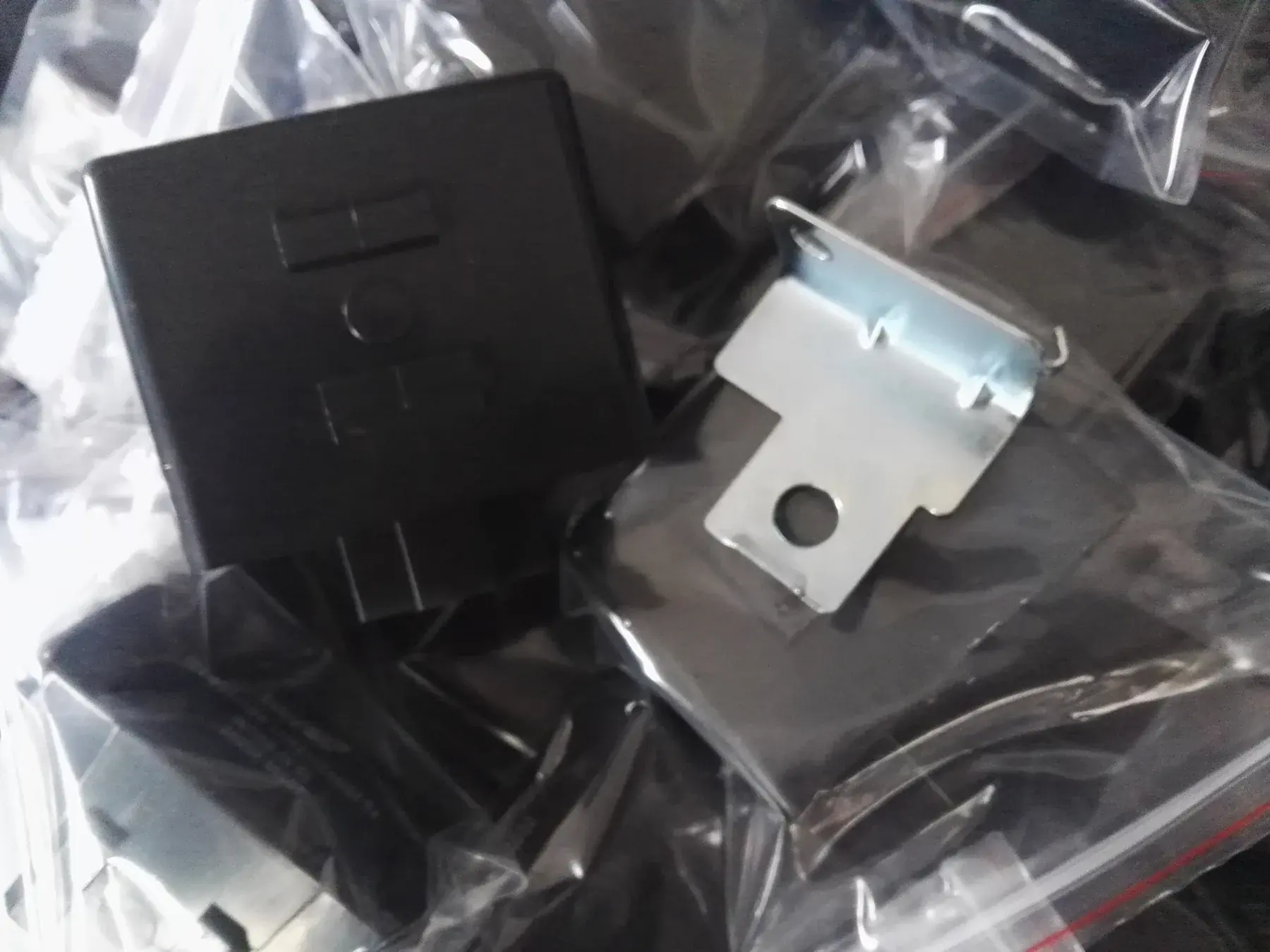 Relay housings and mounting brackets bagged individually before boxing