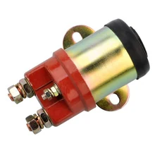 Red automotive starter solenoid with brass terminal studs, black top cap and mounting bracket on white background
