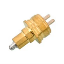 M27X1.0 reversing light switch with brass body and black insulating housing, mounted on a transmission housing