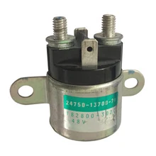 A cylindrical silver electrical component with a black top, two threaded terminals, and mounting tabs.