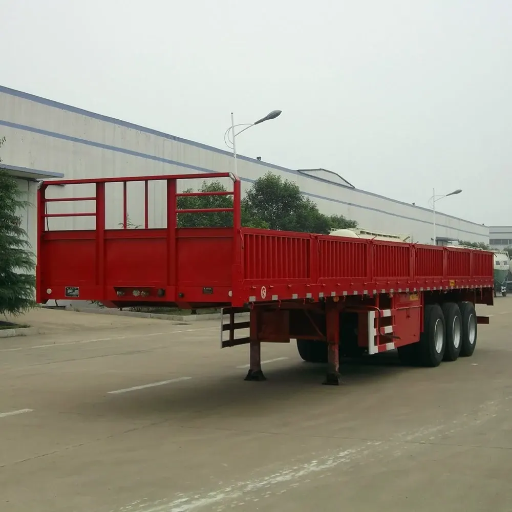 13-meter 3-axle flatbed semi-trailer with side walls, parked on a yard, front three-quarter view
