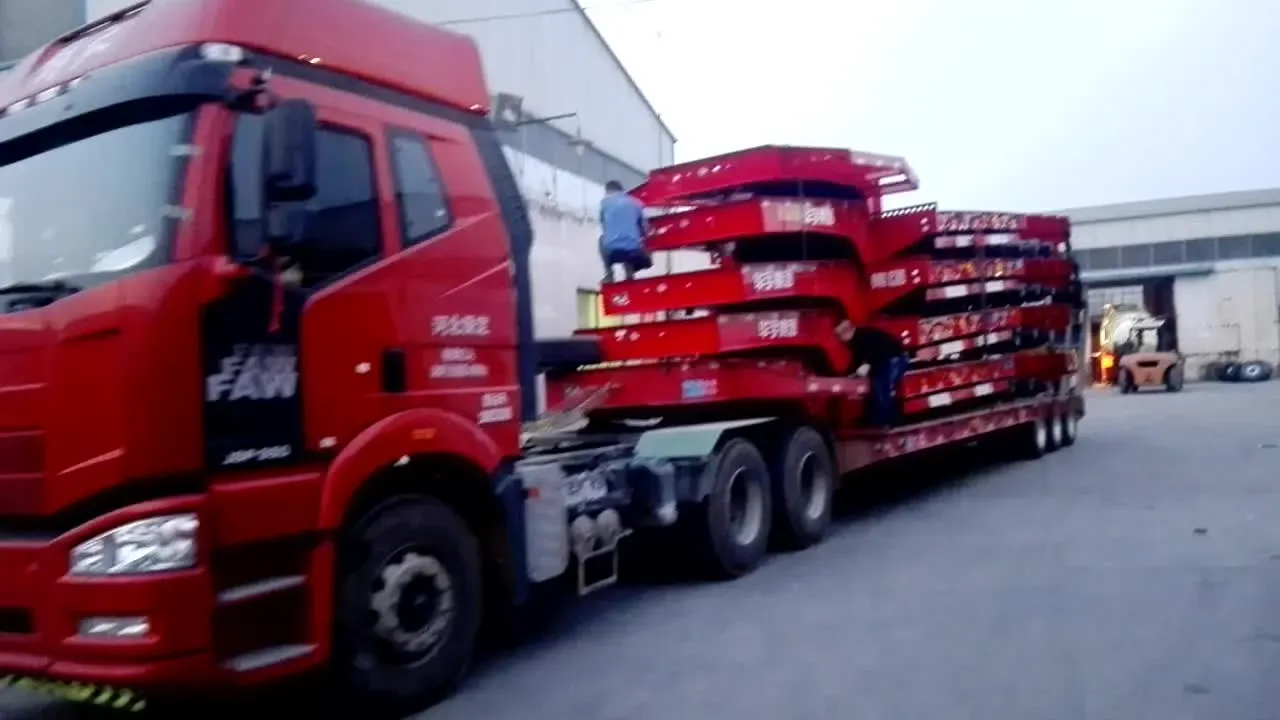 Side view of a 3-axle low loader trailer with 12R22.5 tyres and hydraulic ladder raised