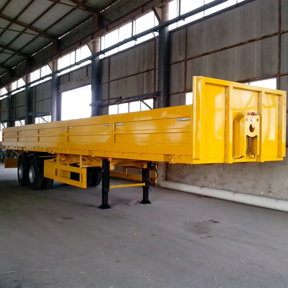 Silver two-axle side wall semi-trailer parked on a lot