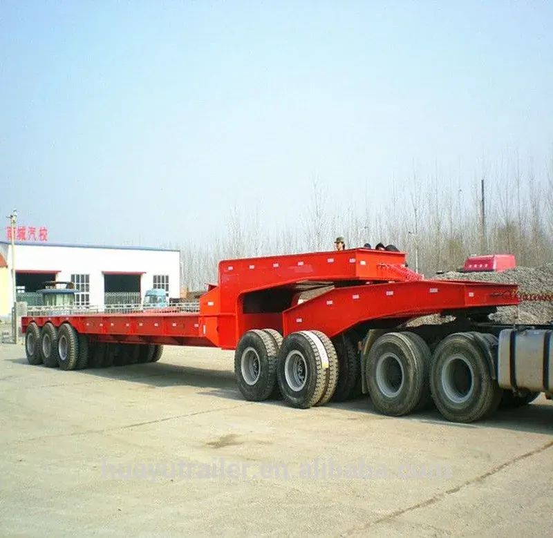 200-ton heavy-duty lowboy semi trailer parked on a yard, front three-quarter view showing the drop bed and front axles