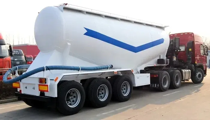 3-axle semi-trailer with 13000mm length, steel tank, and 12R22.5 tyres, parked on a yard