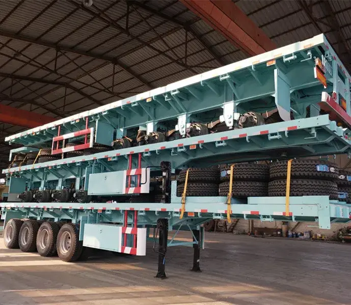 Side view of a three-axle flatbed semi-trailer