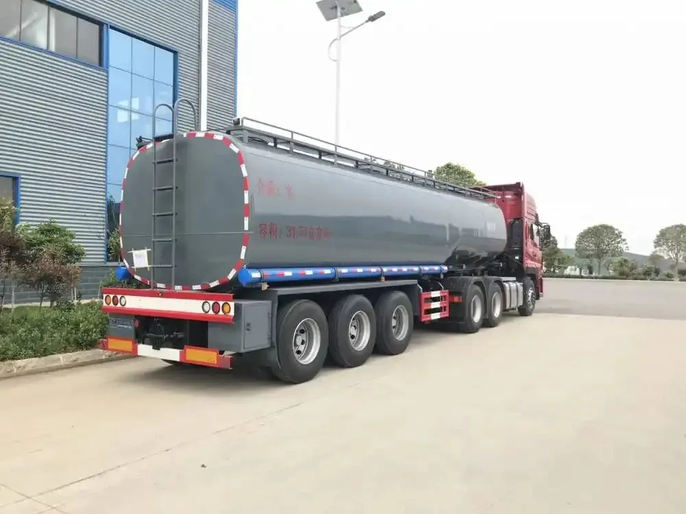 White fuel tanker truck parked on a yard, side view