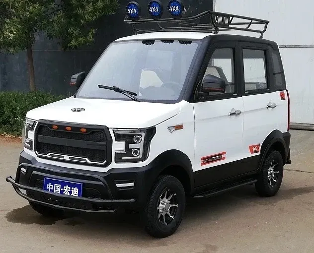 White 4-wheel electric car with five doors parked on a concrete yard, front three-quarter view
