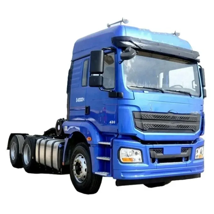 Red 6x4 tractor head parked on a yard, front three-quarter view with high roof cab