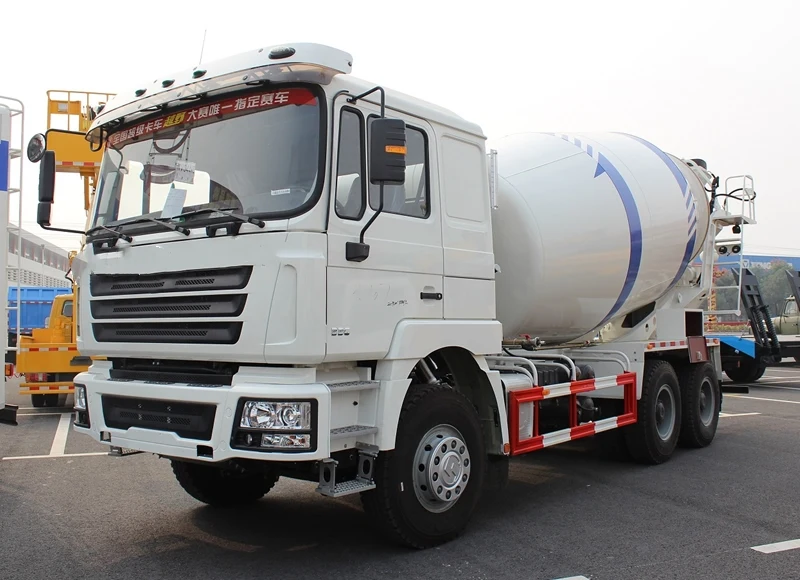 White ZZ1257N3841W cement mixer truck parked on a yard, front three-quarter view showing the HOWO76 cab and drum