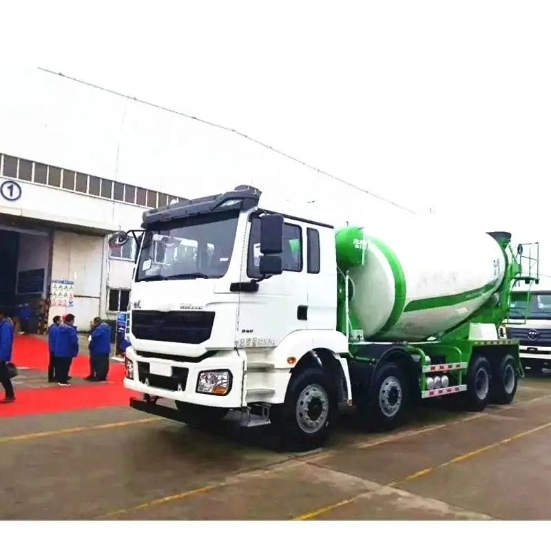 White 6x4 concrete mixer truck parked on a yard, front three-quarter view showing the cab and front grille