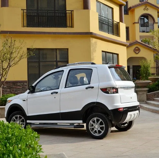 Front three-quarter view of a white electric mini car with solar panel on roof and 155/65-R13 tires