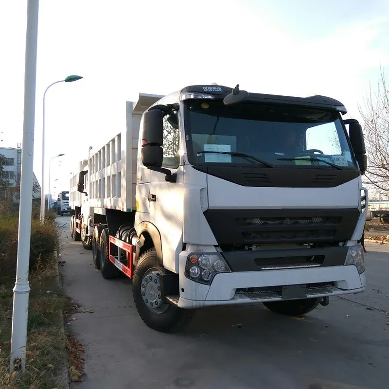 White 6x4 dumper truck parked on a yard, side view