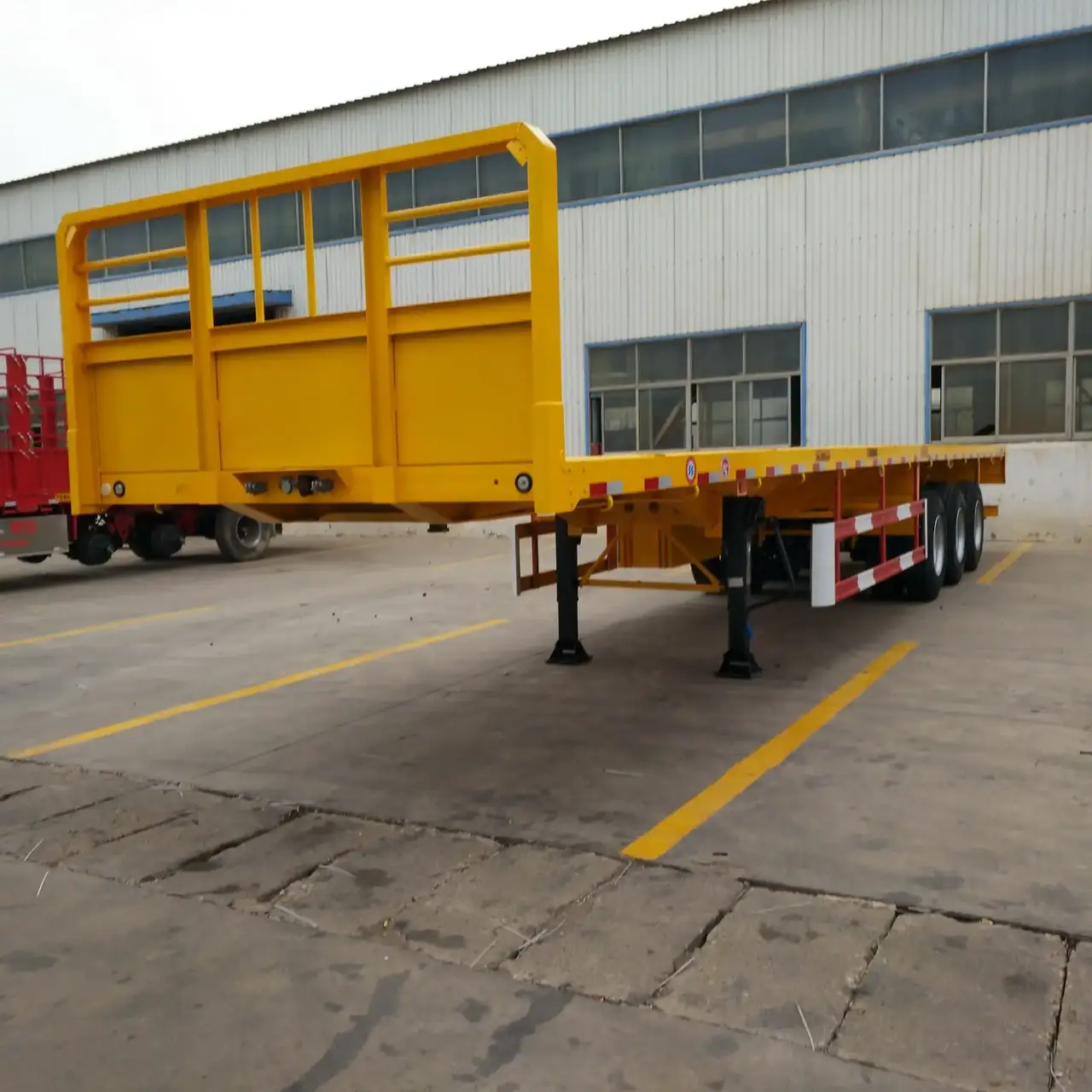 Side view of a 40ft flatbed semi trailer with 3 axles, showing mechanical suspension and 12R22.5 tyres