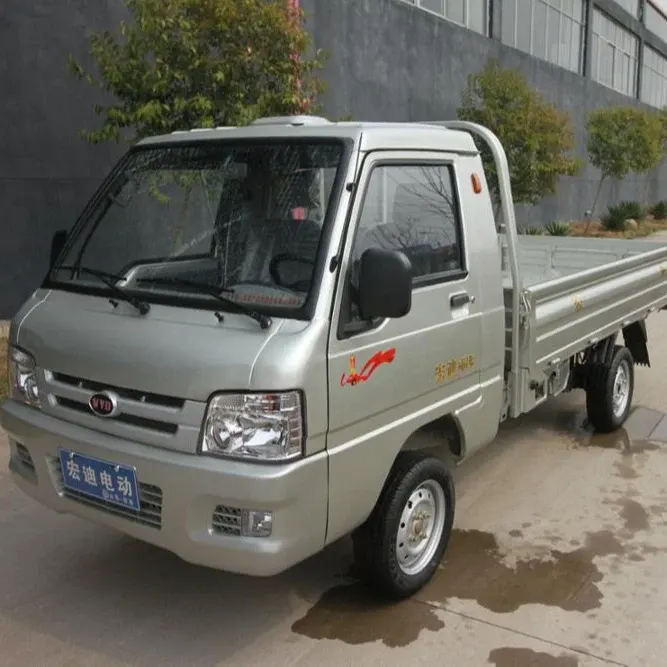 Front three-quarter view of the white electric mini pickup truck with 165/70R13 tyres and closed cabin