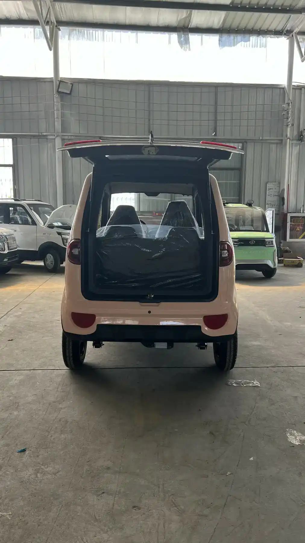 Front three-quarter view of a white 4-wheel solar electric car with solar panel on roof