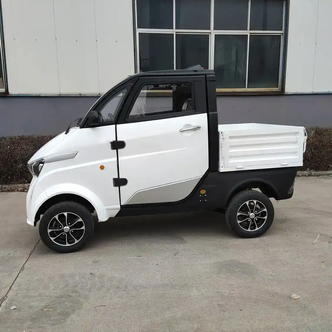 Front three-quarter view of a white EEC L6e approved electric van with closed body and middle steering