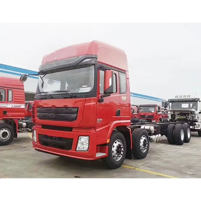 Front three-quarter view of a red 6x2 tractor truck with high-roof cab and MAN axles