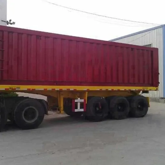 Rear view of a 3-axle rear dump semi trailer with hydraulic lift cylinders and dump gate open