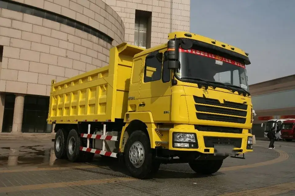 Front three-quarter view of a white 6x4 dump truck with a single sleeper cab and air conditioning