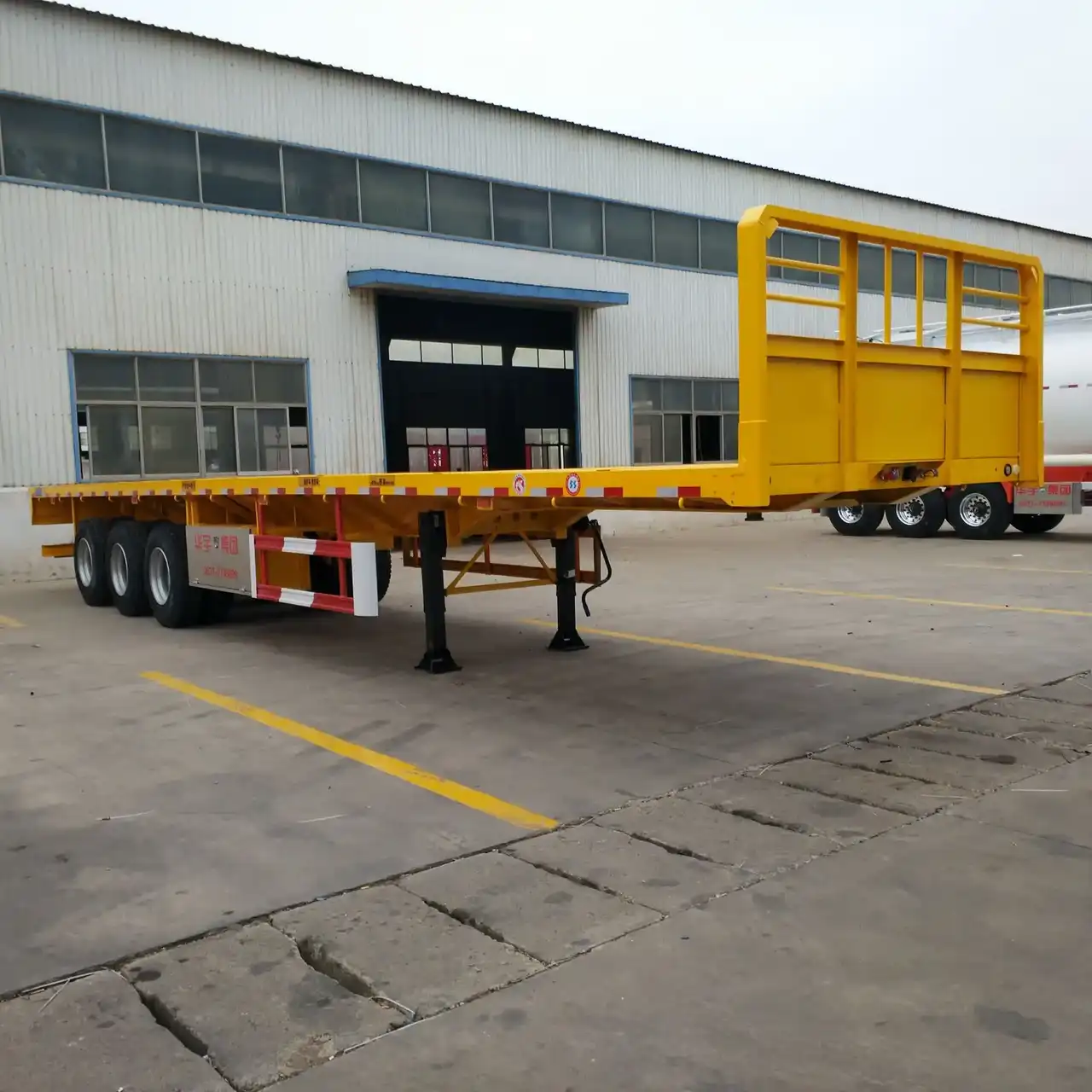 3-axle flatbed semi trailer in white with high bed, front three-quarter view