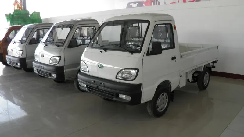 Silver GOne-T01 mini truck parked on a yard, front three-quarter view with cargo box open