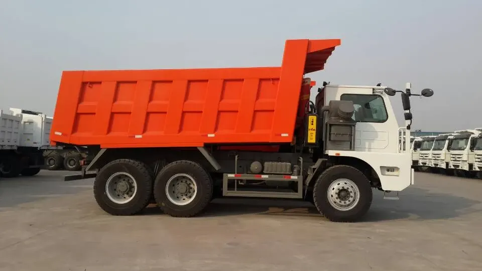 White HOWO 70T mining dump truck parked on a yard, side view
