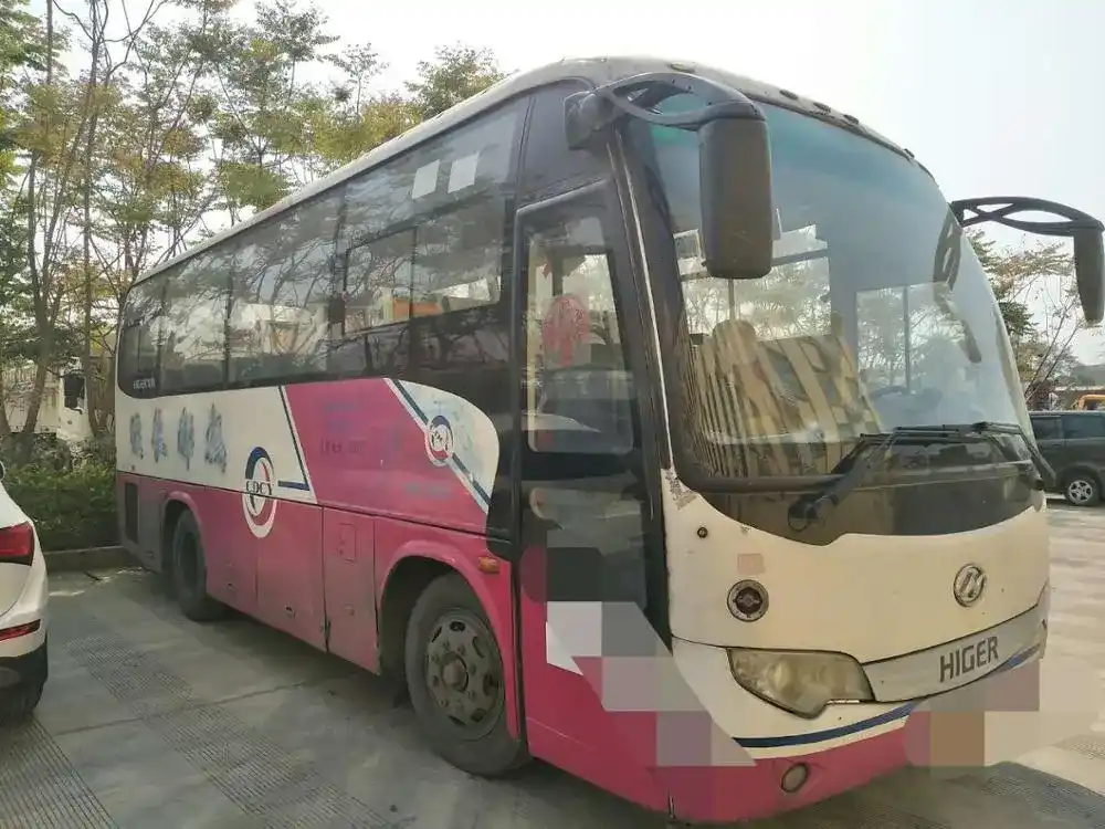 12-meter luxury bus parked on a yard, front three-quarter view with air-conditioned cabin