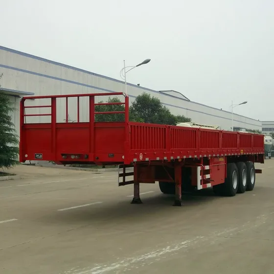13-meter 3-axle flatbed semi-trailer with side walls, parked on a yard, front three-quarter view