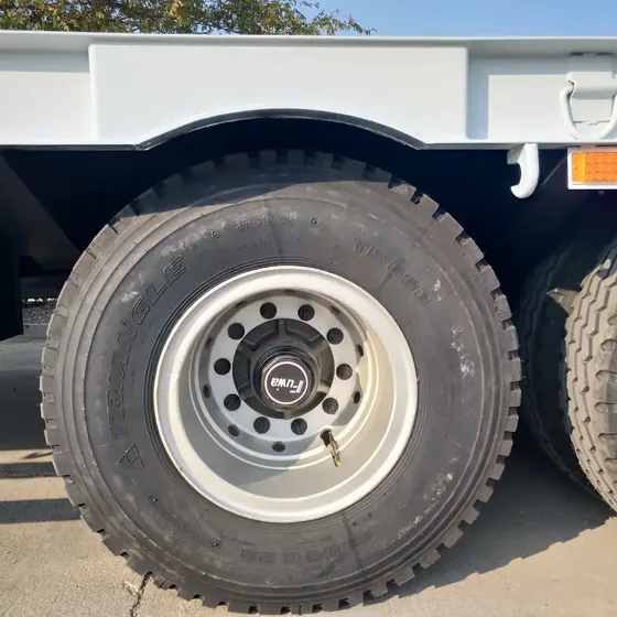 Trailer parked on a yard with the cab and tractor head connected, ready for transport
