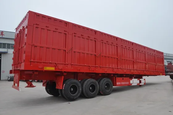 Side view of a 3-axle steel dump trailer with leaf spring suspension and side-tipping mechanism