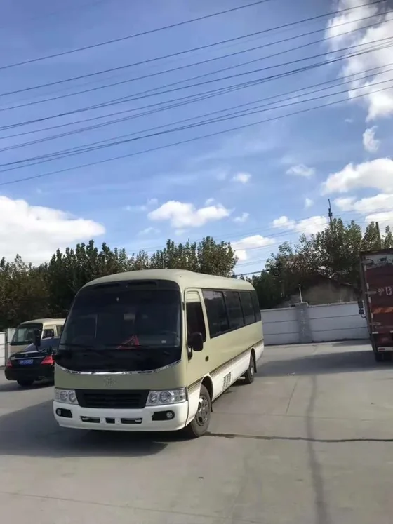 Rear view of the Toyota Coaster bus with rear doors and license plate