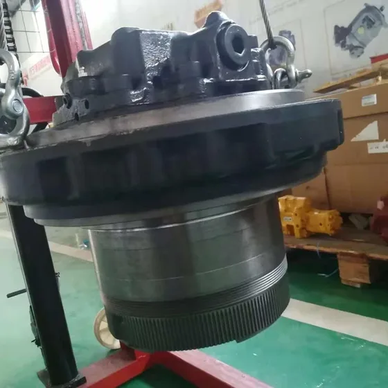 Close-up of the travel motor housing with CNC machining marks and part number labels