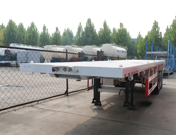 Side view of a 3-axle 40ft flatbed container semi-trailer with 1200R20 tyres and leaf spring suspension
