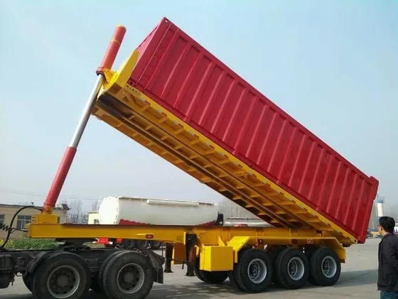 Rear view of the trailer with the dump gate open and hydraulic cylinders in operation