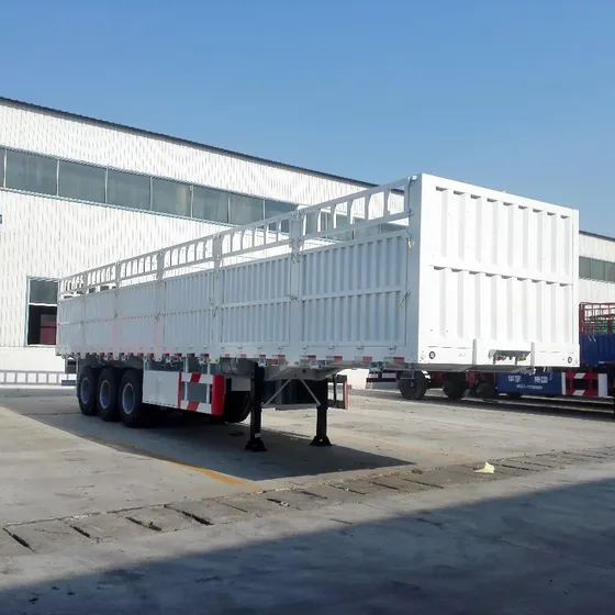 Side view of 3-axle side wall cargo semi trailer with 12R22.5 tyres and checkered floor