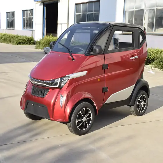 White 3-seater electric van with closed body parked on a city street, front view