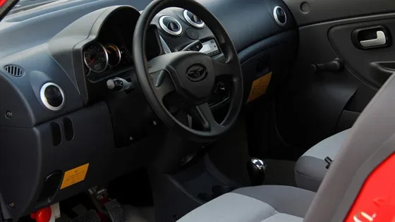 Interior with four seats, steering wheel, and dashboard controls