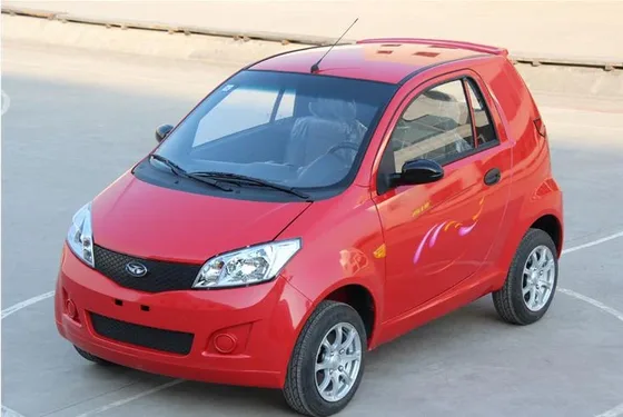 Front three-quarter view of a 4-seat electric hatchback with 155/65R13 tyres and white body