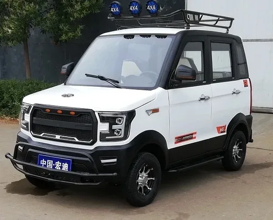 Four-wheel electric car with five doors and four seats, white body, parked on a paved lot