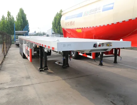 Side view of a 40-foot flat bed semi trailer with three 13-ton Fuwa axles and leaf spring suspension
