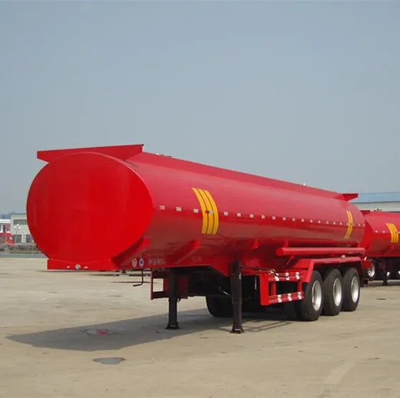 Rear view of the tanker with discharge valves, rubber hoses, and manhole covers
