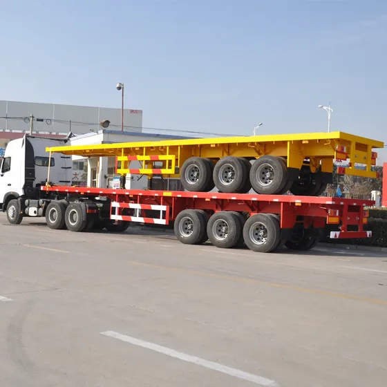 Flatbed platform with corrugated steel and stake pockets, showing cargo securing points