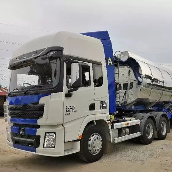 White HOWO 6x4 tractor head parked on a yard, front three-quarter view