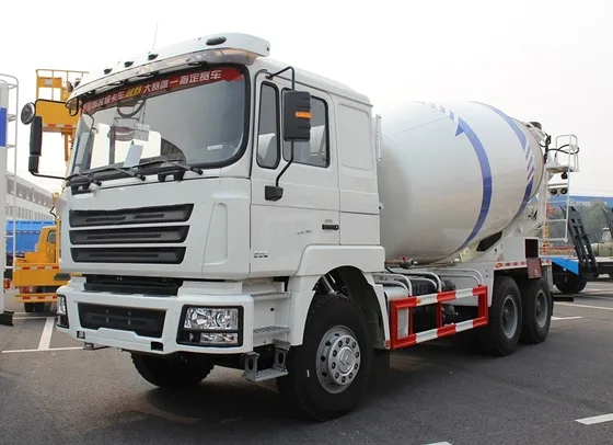 White 6x4 concrete mixer truck parked on a yard, front three-quarter view showing the cab and drum