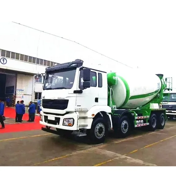 White ZZ1257M3241 concrete mixer truck parked on a yard, front three-quarter view showing the HOWO70 cab and drum