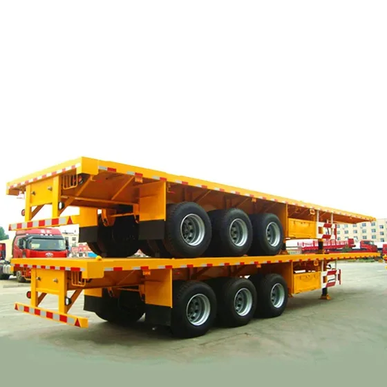 Used 3-axle flatbed semi-trailer parked on a yard, front view showing 13m platform and 1200R20 tyres