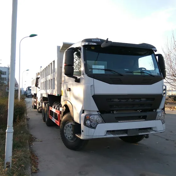 White 6x4 dumper truck parked on a yard, side view