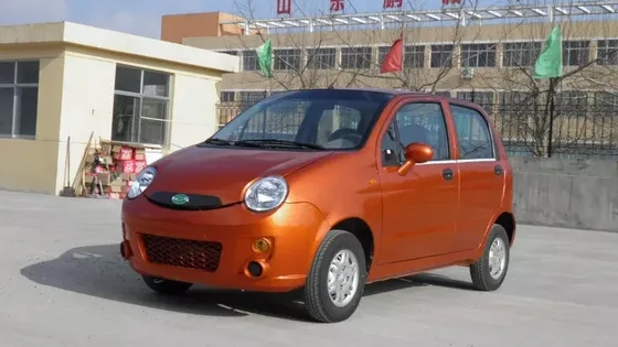 Red eone-S03 electric mini sedan parked on a flat surface, front three-quarter view
