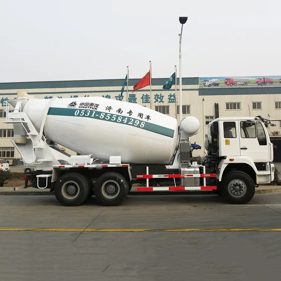 Rear view of the mixer truck with the drum discharge chute and water tank access door